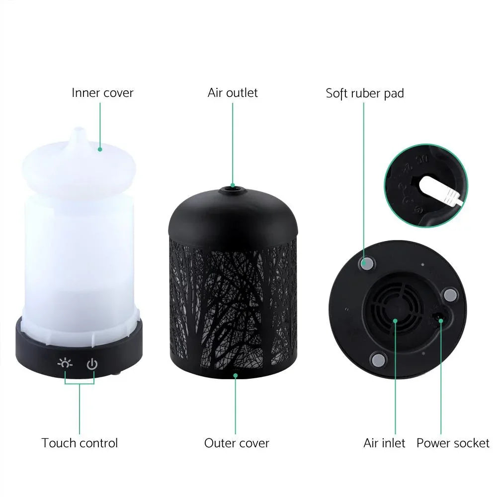 Black aroma diffuser illuminated as LED night light in dim room setting.