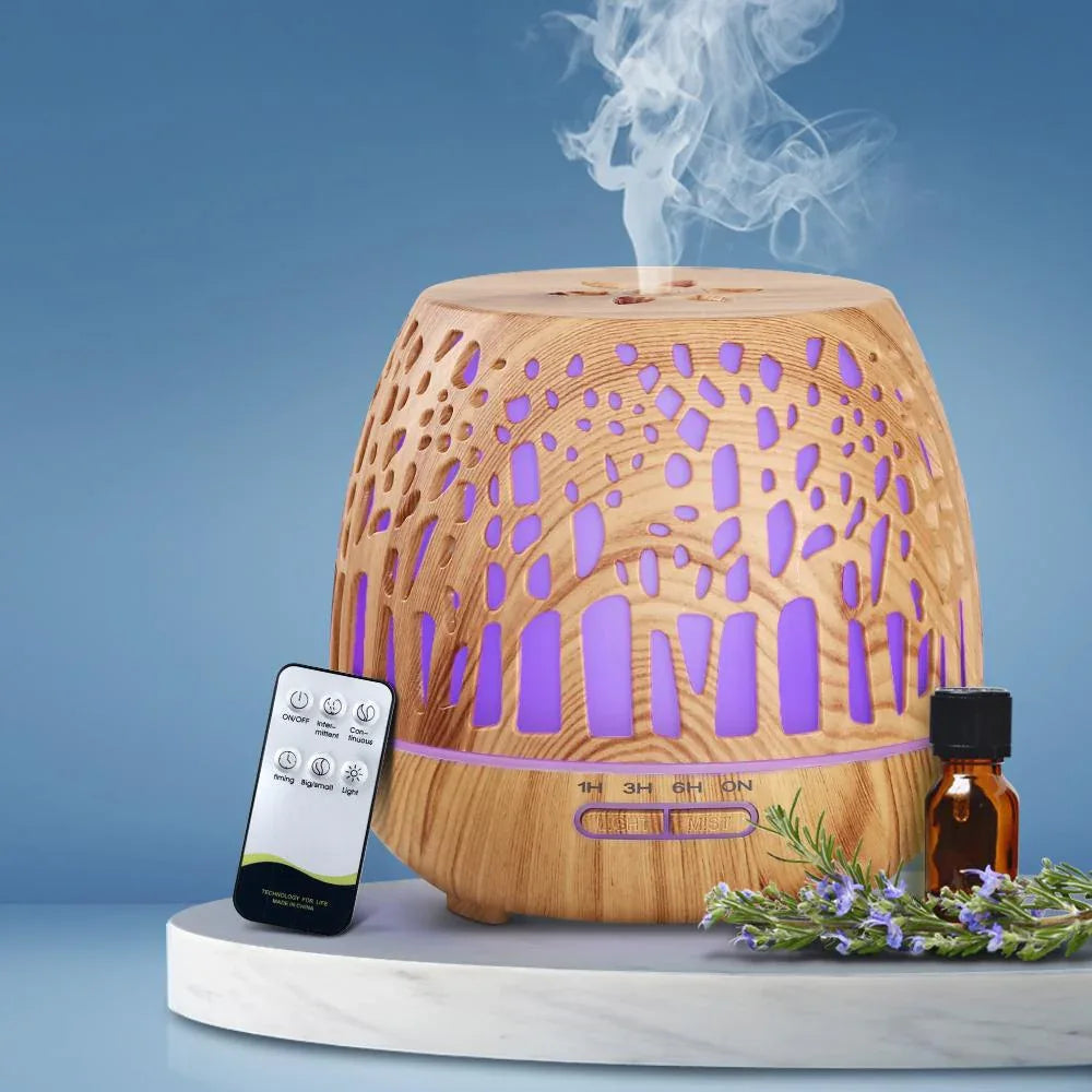 Compact aroma diffuser resting on wooden surface with subtle ambient lighting