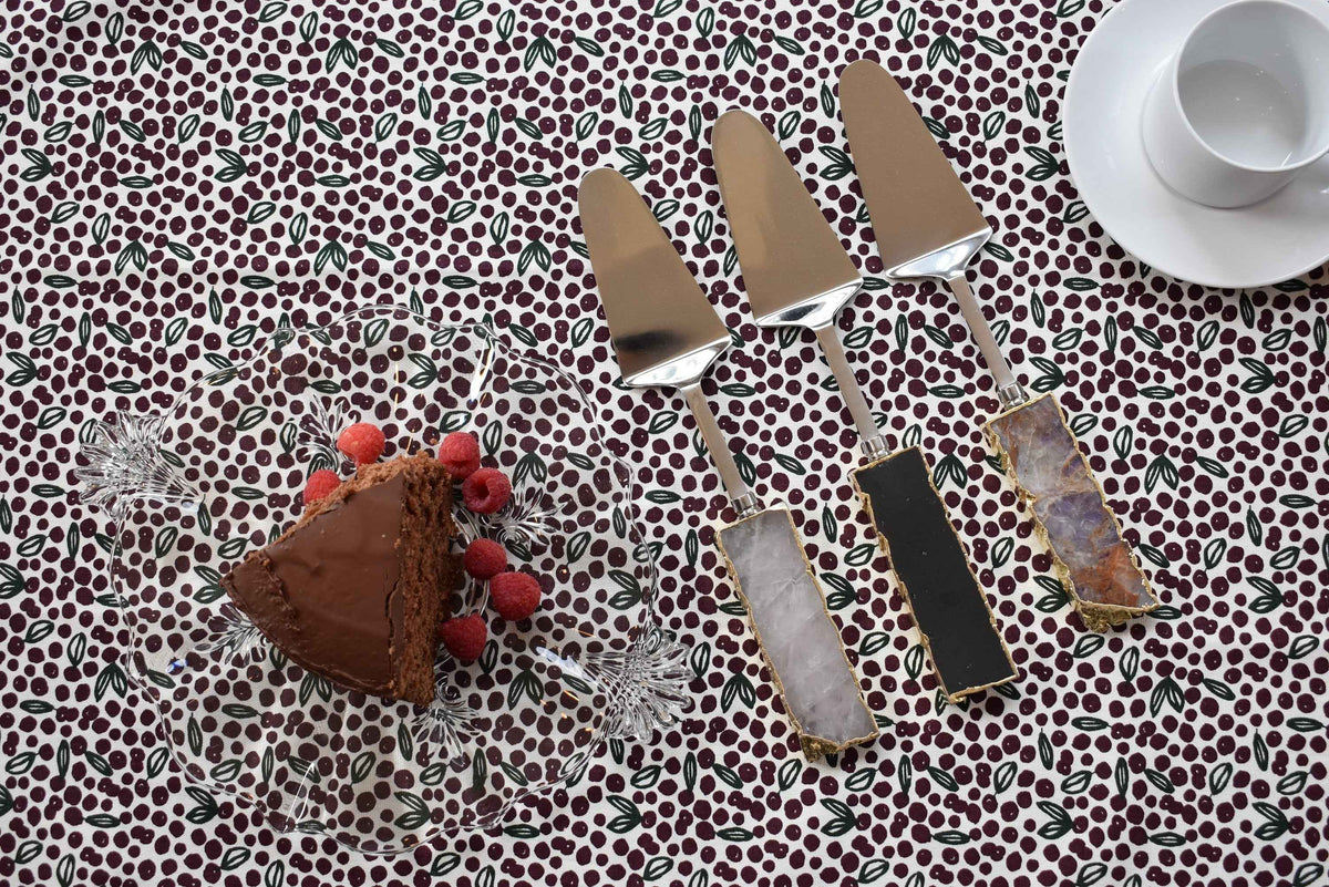 Close-up of gemstone cake server featuring clear quartz handle and gold-plated trim