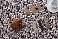 Close-up of gemstone cake server featuring clear quartz handle and gold-plated trim