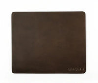 Top-down view of dark brown leather mouse pad highlighting grain texture.