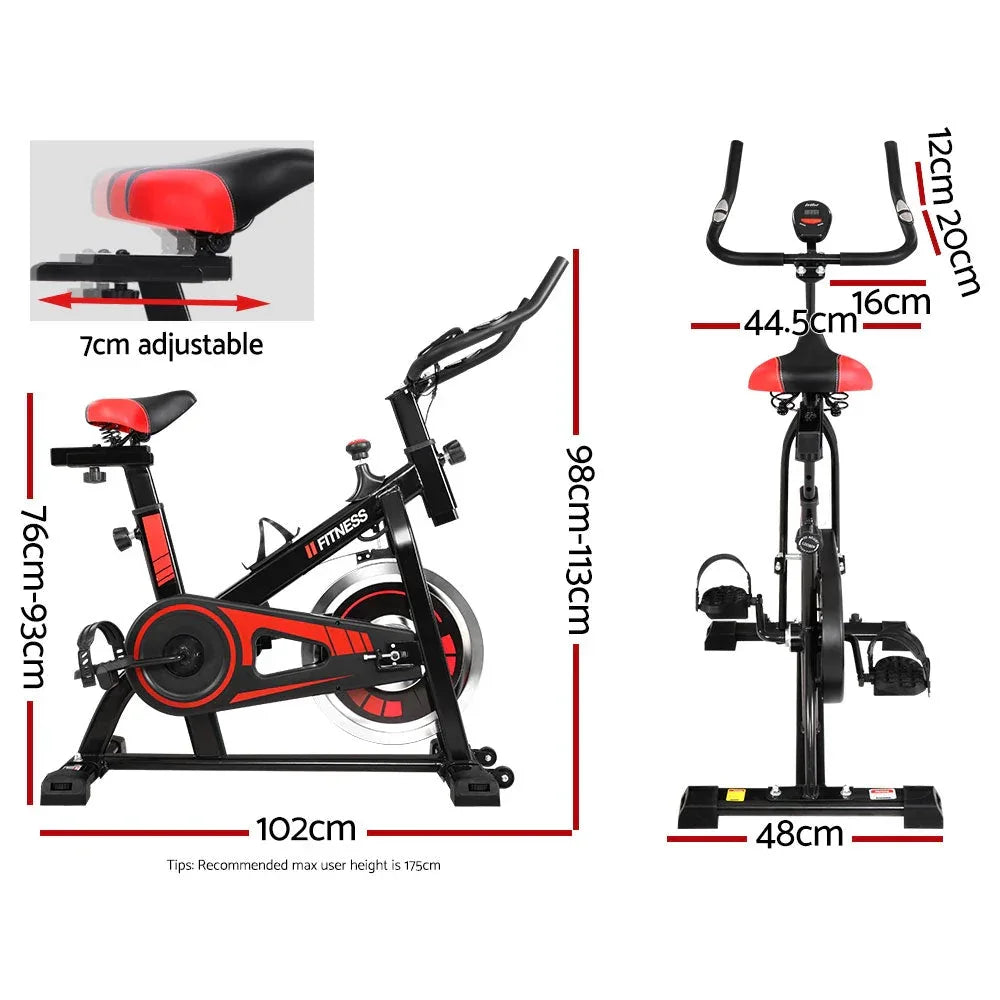 Side profile of black spin bike highlighting pedals and seat