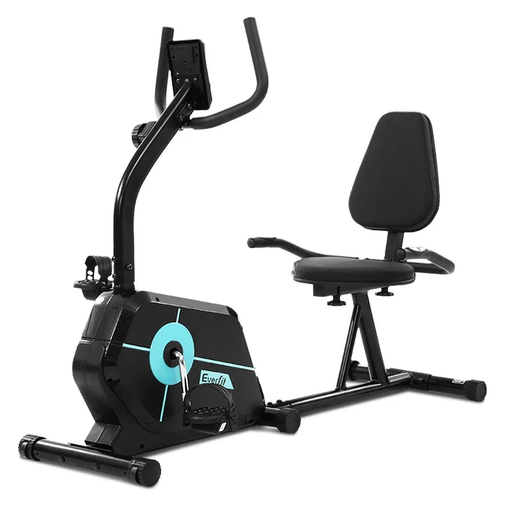 Close-up of exercise bike pedals and cushioned seat with backrest