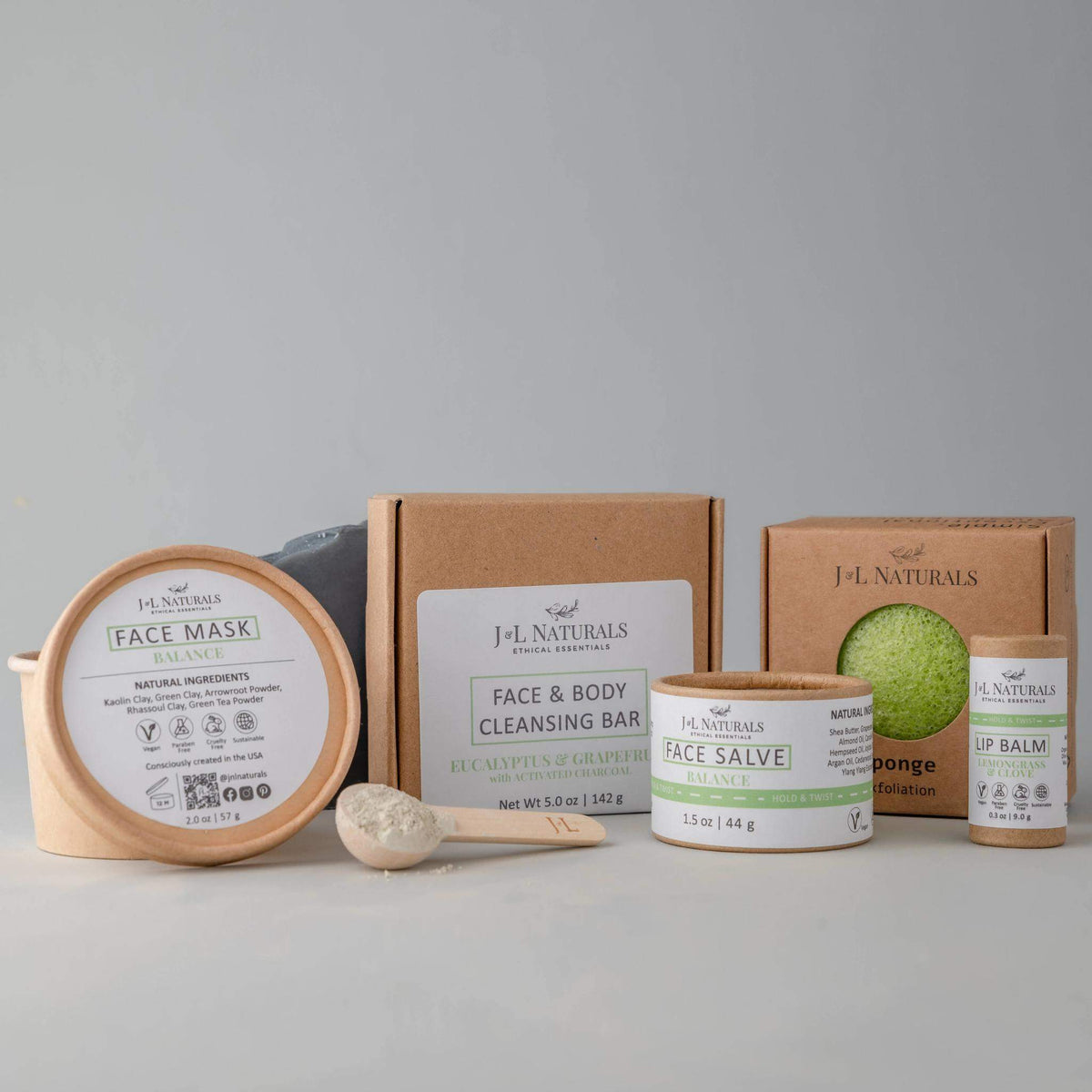 Balance skin regimen kit with cleansing bar, konjac sponge, face salve, and mask on white background.