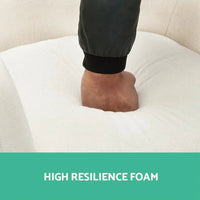 Armchair displayed in natural light emphasizing plush cushioning and beige upholstery