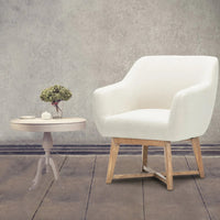 Beige tub lounge armchair angled to show its comfortable seat padding and fabric texture