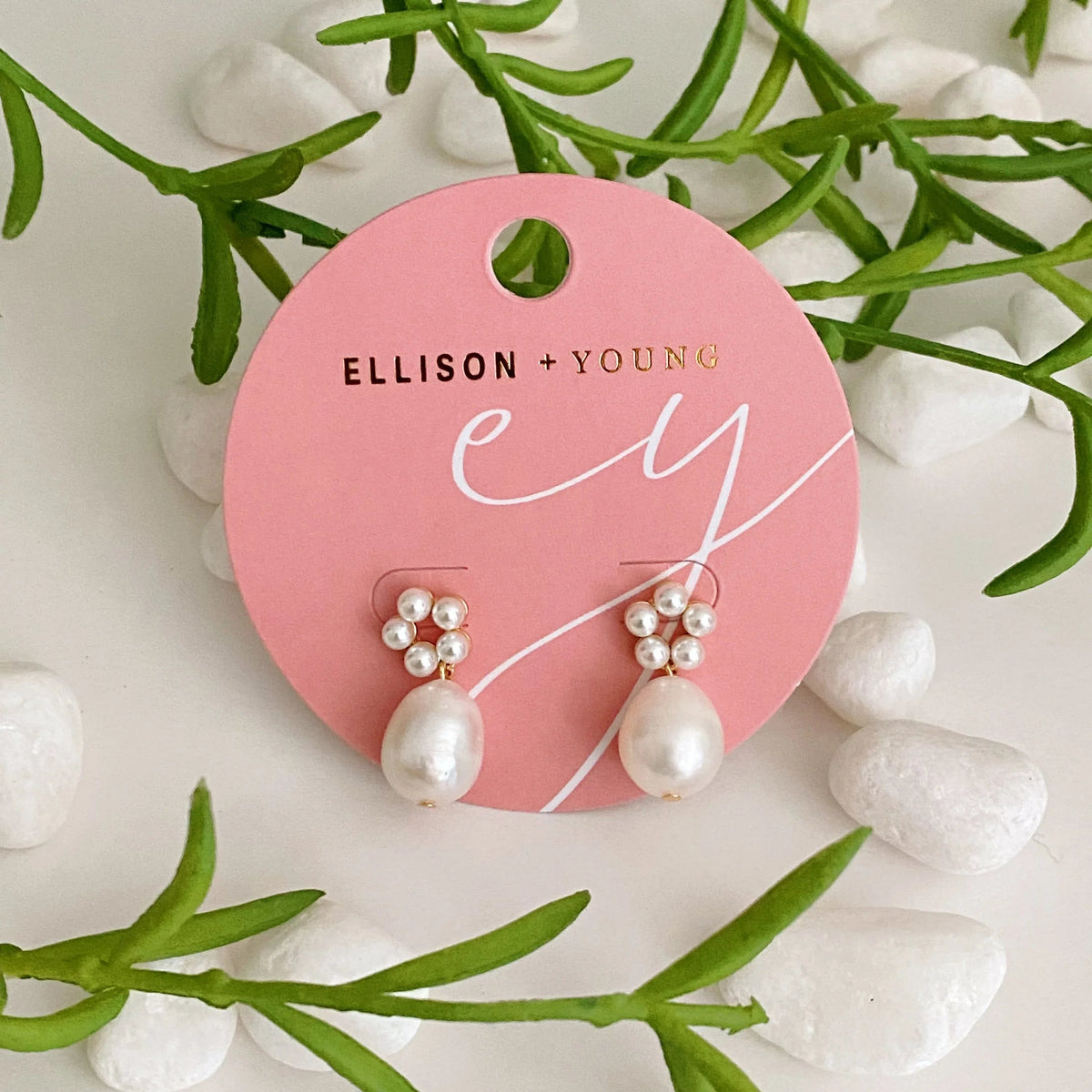 Blooming Freshwater Pearl Drop Earrings styled on a white surface emphasizing the delicate design and size.