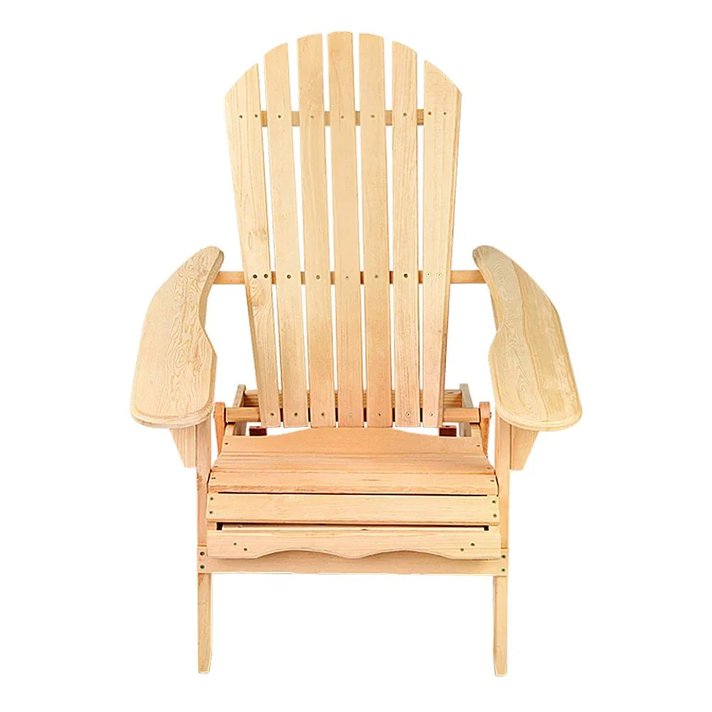 Folded wooden outdoor chair leaning against a rustic fence on summer day.