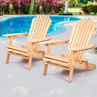 Wooden patio chair folded and resting on light wooden deck outdoors.