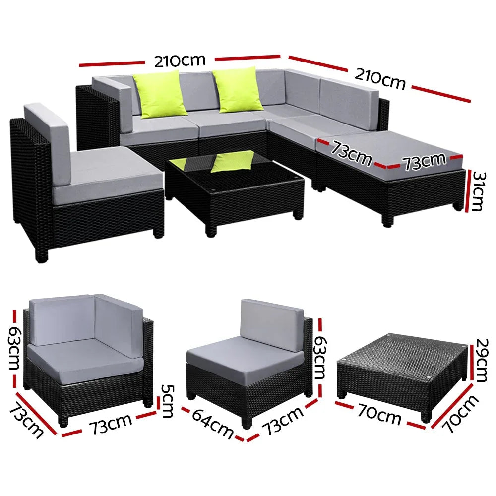 Close-up of plush cushions on dark wicker sofas arranged in an L shape with coffee table.