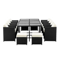 Side angle of the outdoor wicker dining set with chairs arranged around the table on stone tiles.