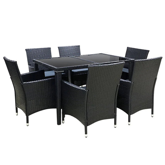 Seven-piece outdoor dining set with black rattan chairs and glass-top table on patio