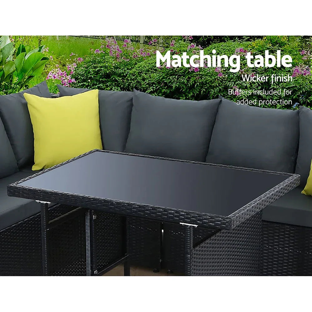 Close-up of weather-resistant woven wicker and soft beige cushions of outdoor sofa set.