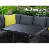 Close-up of weather-resistant woven wicker and soft beige cushions of outdoor sofa set.