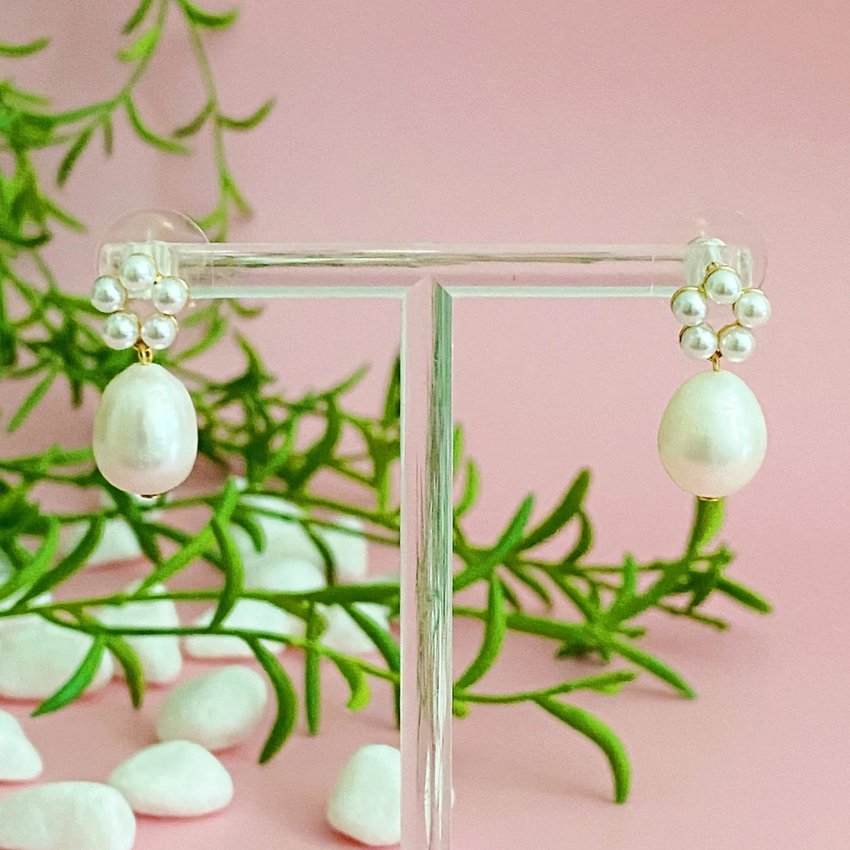 Side profile of gold-plated earrings highlighting the layered pearl bead design.
