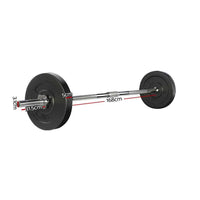 Close-up of black rubber-coated 5kg barbell weight plates stacked beside chrome bar
