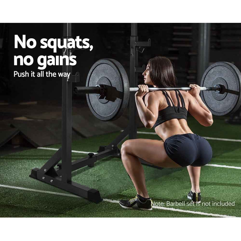 Side view of squat rack pair with barbell resting on adjustable holders in gym setup.