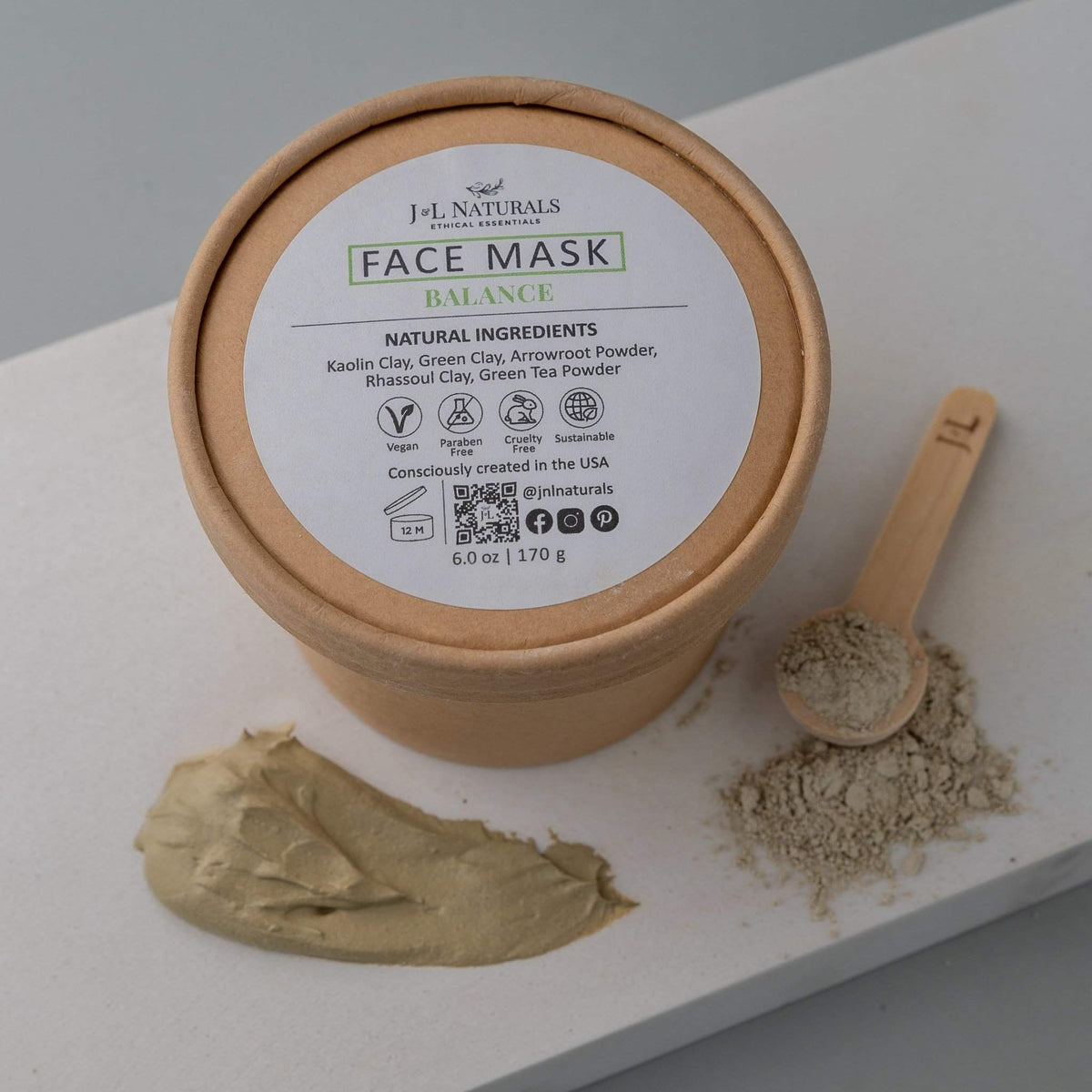 Open jar of balance face mask with smooth texture on rustic surface.