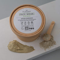 Open jar of balance face mask with smooth texture on rustic surface.