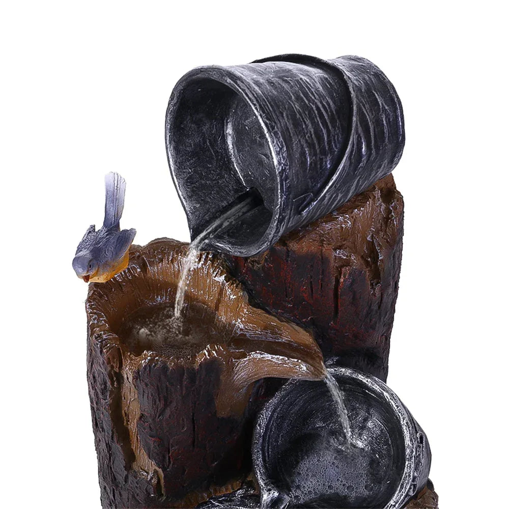 Side view of black solar water fountain featuring polyresin buckets pouring water down tiers.