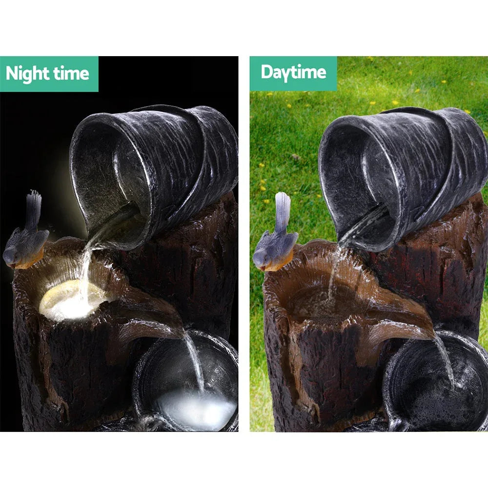 Top-down angle of three-tier outdoor solar fountain with flowing water in each tier.