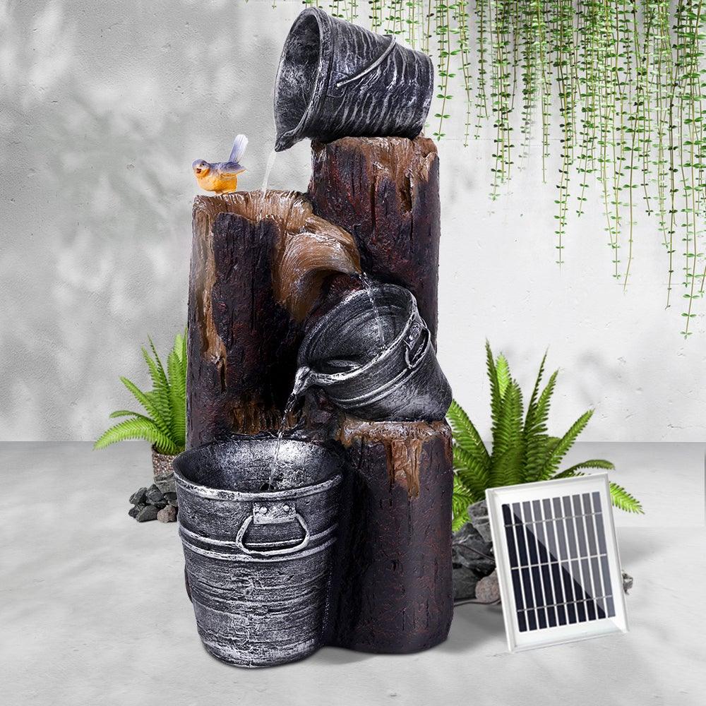 Outdoor solar water fountain with three cascading tiers designed as bucket bird baths.