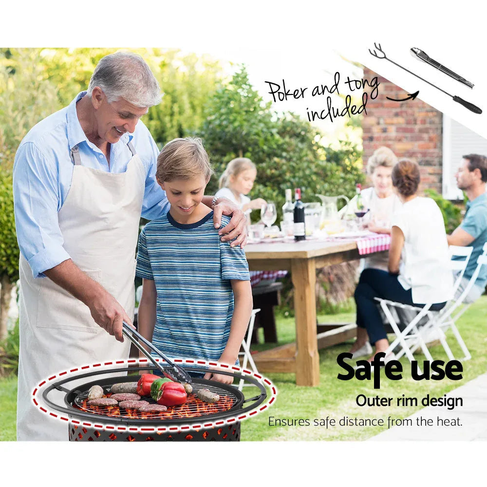 Stainless steel grill plate set on fire pit with glowing embers below.
