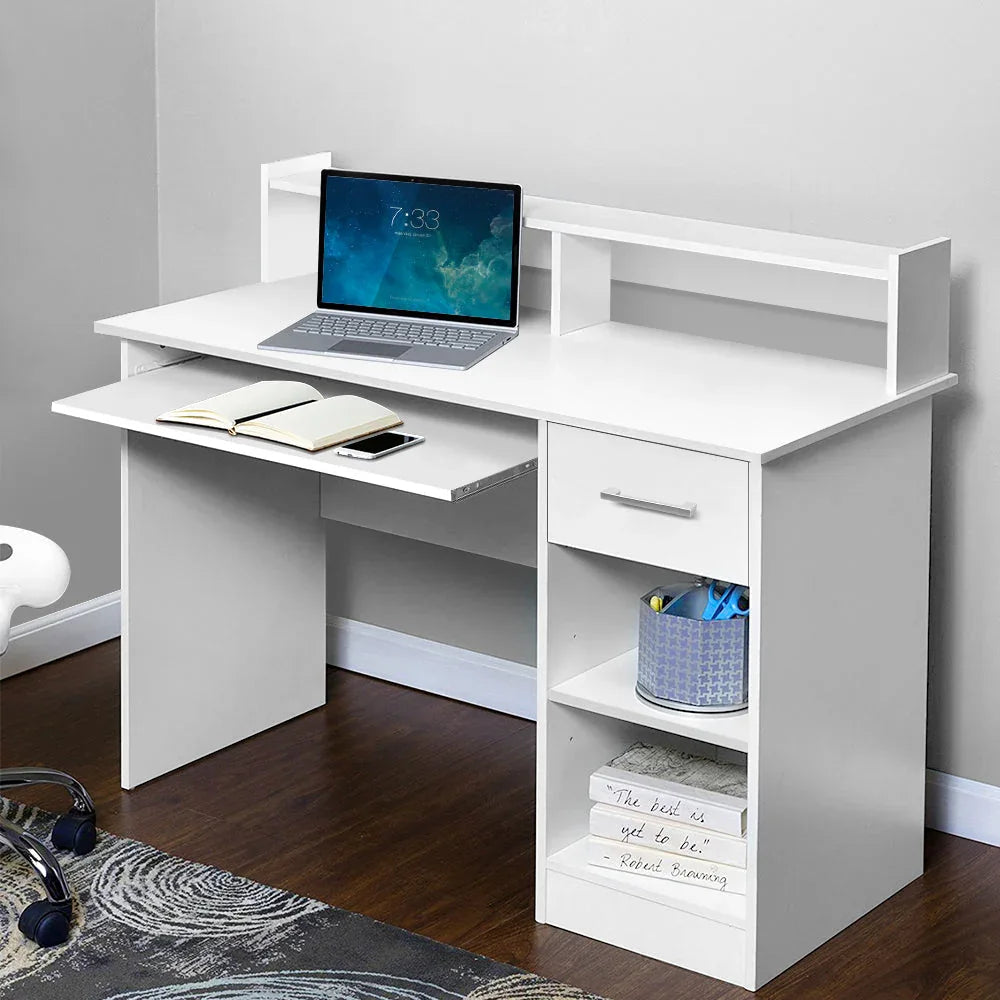 White office desk angled view showing storage sections and keyboard tray.