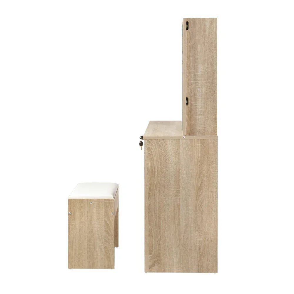 Thick padded wooden dressing stool matching the vanity set in cozy room corner.