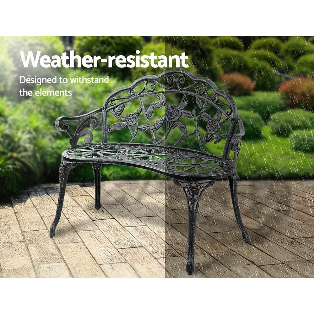 Green Victorian bench with sturdy cast iron legs setup in outdoor garden space.