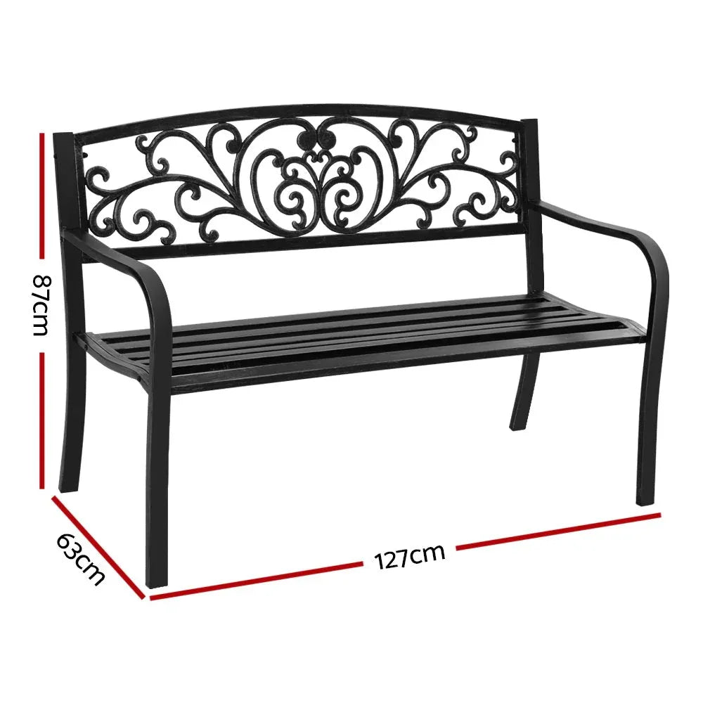 Close-up of garden bench's floral backrest with decorative metalwork in black finish.