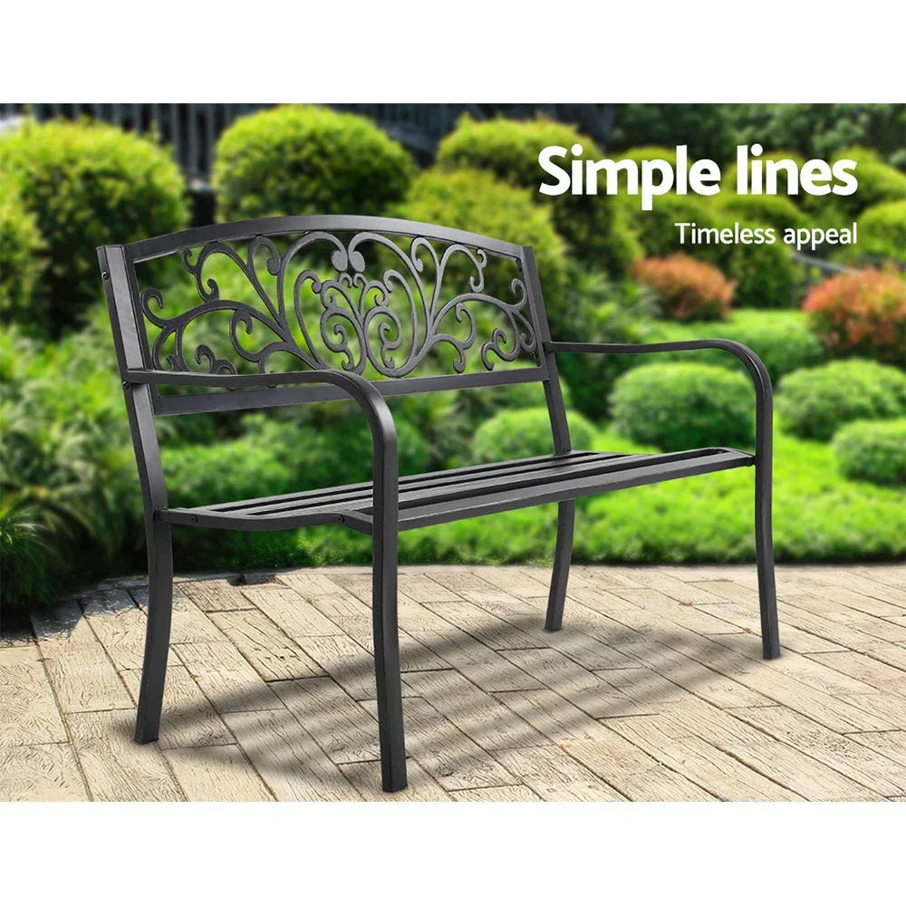 Back angle of garden bench showcasing detailed wrought-iron style floral pattern.
