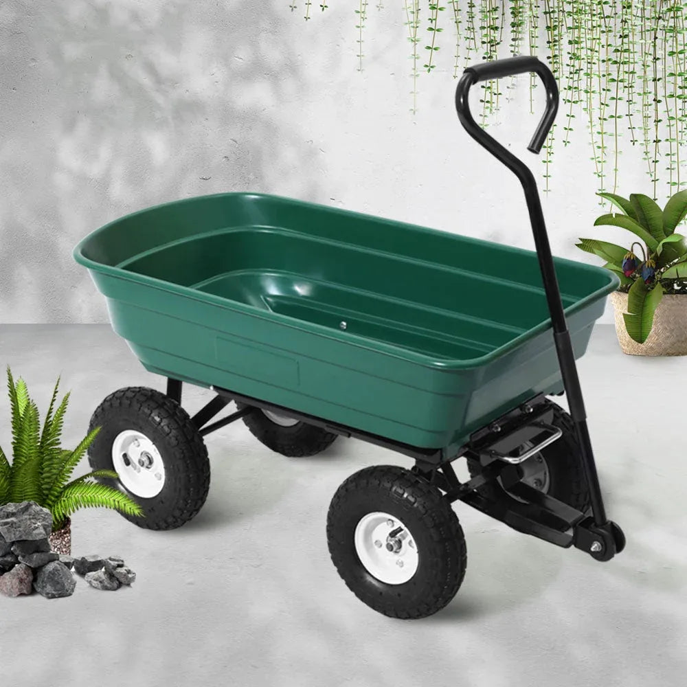 Rear view of green garden dump cart with handle and wheel details on outdoor terrain