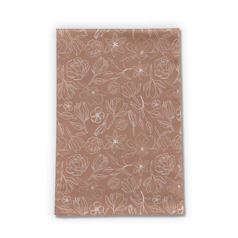 Copper Magnolia Tea Towel displayed folded on a kitchen counter with soft natural light.