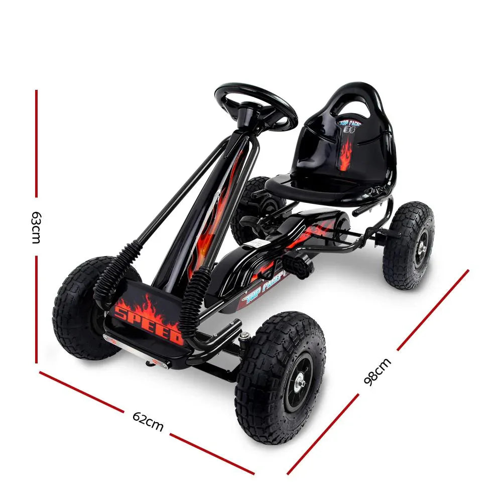 Side view of black pedal go kart car revealing pedals and steering wheel