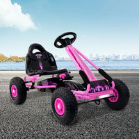 Front-facing kids go kart in vibrant red with durable plastic body and steering wheel.