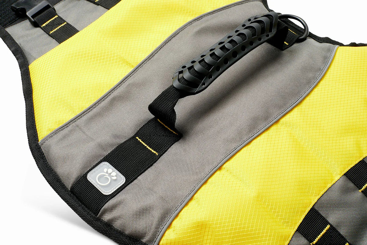Yellow dog life vest showing adjustable waist strap and D-ring for leash attachment