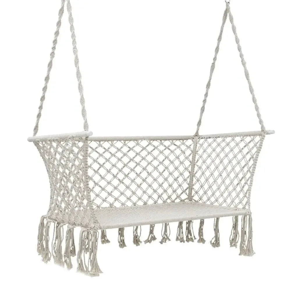 Two-person cream-colored Gardeon hammock chair hanging outdoors with tassel details.