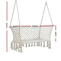 Close-up of the cream fabric and woven tassels on a double hammock chair.