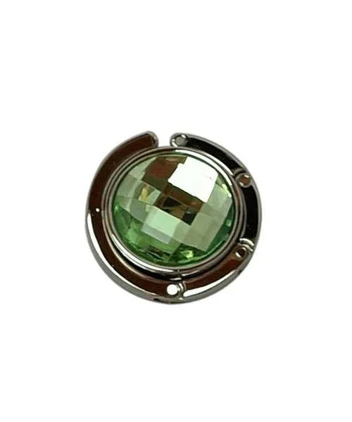 Green handbag hanger unfolded on white background showing magnetic closure.