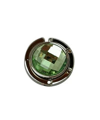 Green handbag hanger unfolded on white background showing magnetic closure.