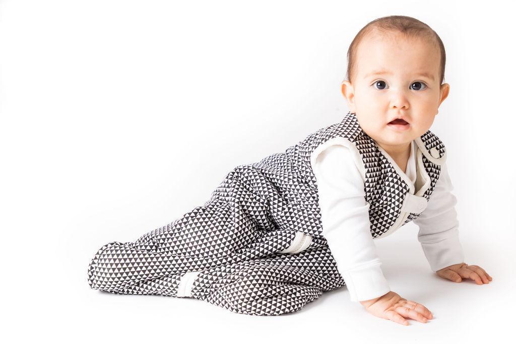 Side view of the Greenwich wearable baby sleep bag laid flat, highlighting its breathable cotton.