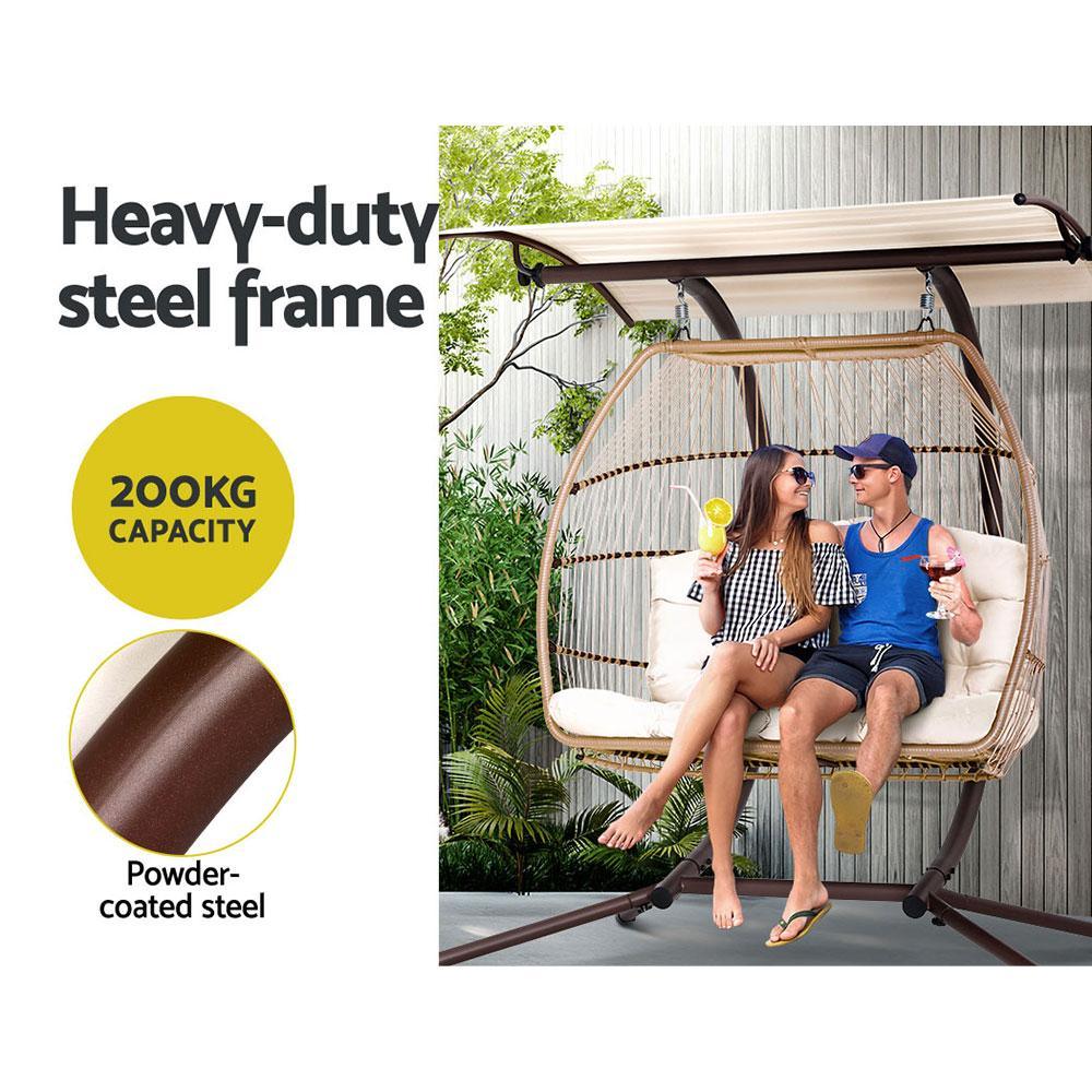 Adjustable canopy of the hanging egg chair shown angled to provide shaded outdoor seating.