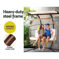Adjustable canopy of the hanging egg chair shown angled to provide shaded outdoor seating.