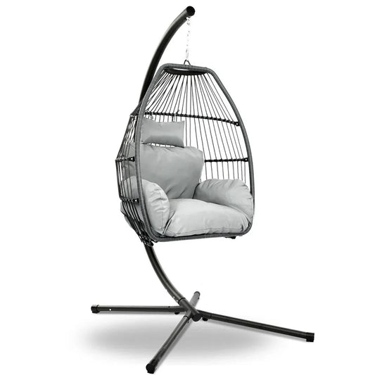 Grey hand-woven wicker hanging egg chair with rope suspension and padded cushion, shown outdoors.