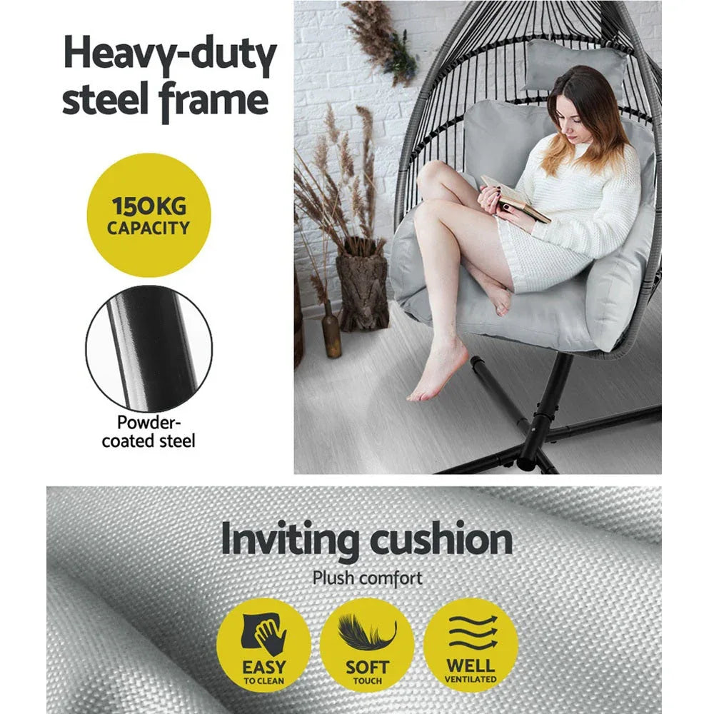 Side view of grey hanging egg chair suspended from a steel stand, cushion inside visible.