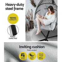 Side view of grey hanging egg chair suspended from a steel stand, cushion inside visible.