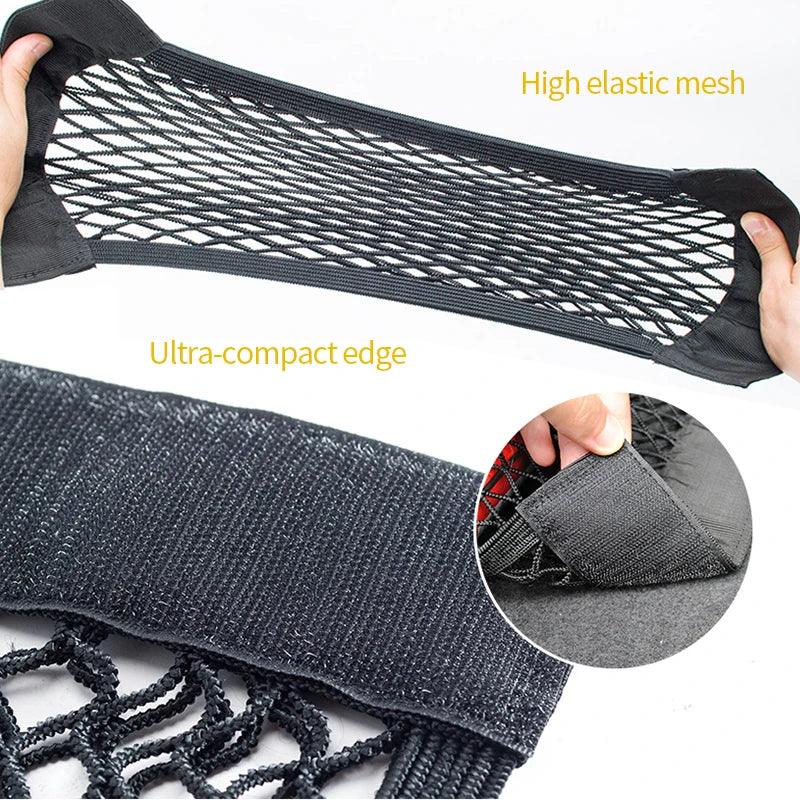 Rear view of car trunk showing black mesh organizer secured with elastic cords.