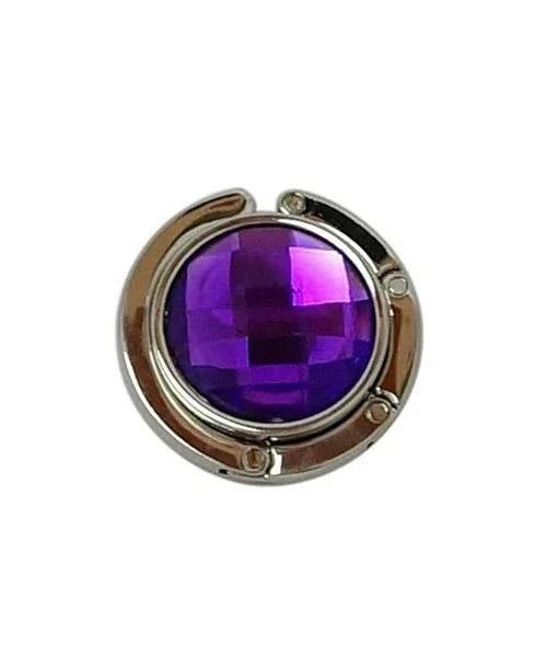 Purple handbag hanger with foldable arm and rhinestone top viewed from above.