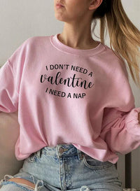 Black sweatshirt displayed with front visible, featuring 'I Don't Need A Valentine' text.